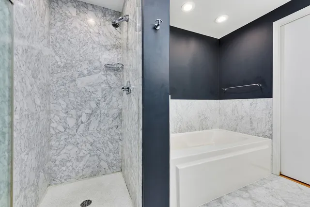 a bathroom with a bathtub and shower