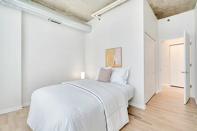 a bedroom with a bed and a night stand