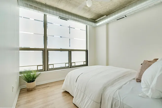 a bedroom with a bed and a window