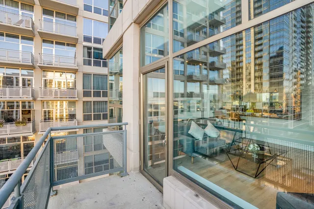 a view of a balcony with wooden floor and iron stairs