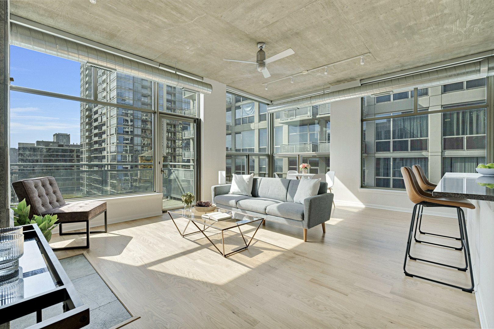 125 East 13th Street, Unit 1213 Chicago, IL 60605 - Photo 2 of 21 a living room with furniture and a floor to ceiling window