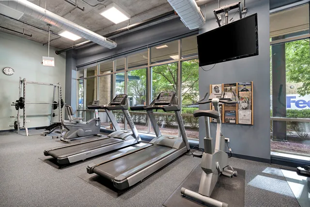 a room with gym equipment and a large window