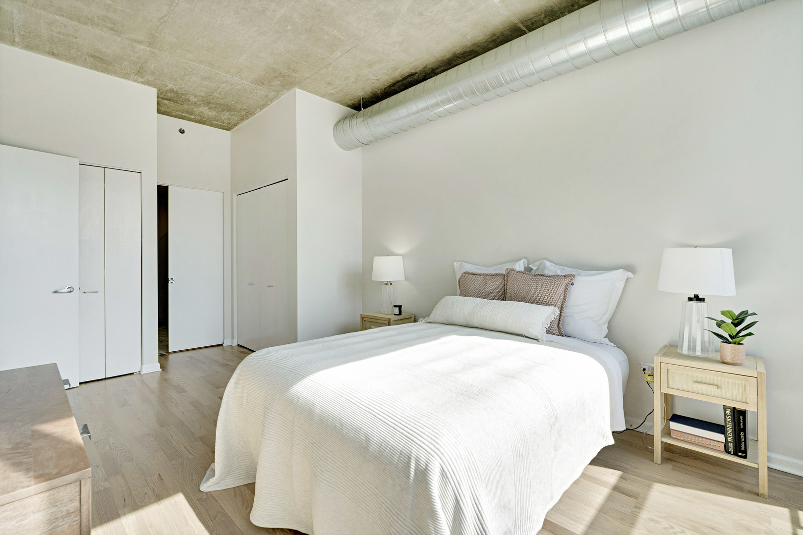 125 East 13th Street, Unit 1213 Chicago, IL 60605 - Photo 9 of 21 a bedroom with a bed and a couch