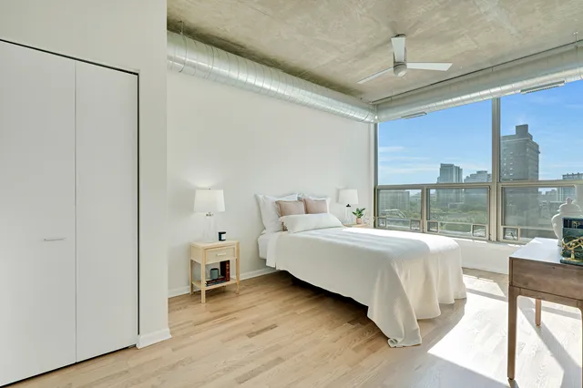 a bed room with a bed and a large window