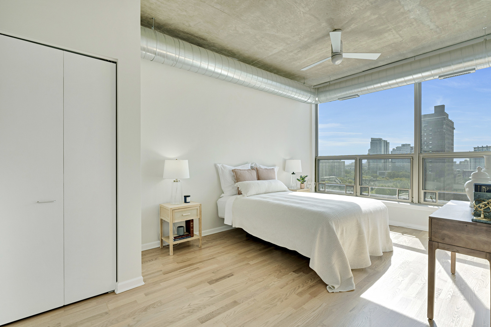 125 East 13th Street, Unit 1213 Chicago, IL 60605 - Photo 10 of 21 a bed room with a bed and a large window