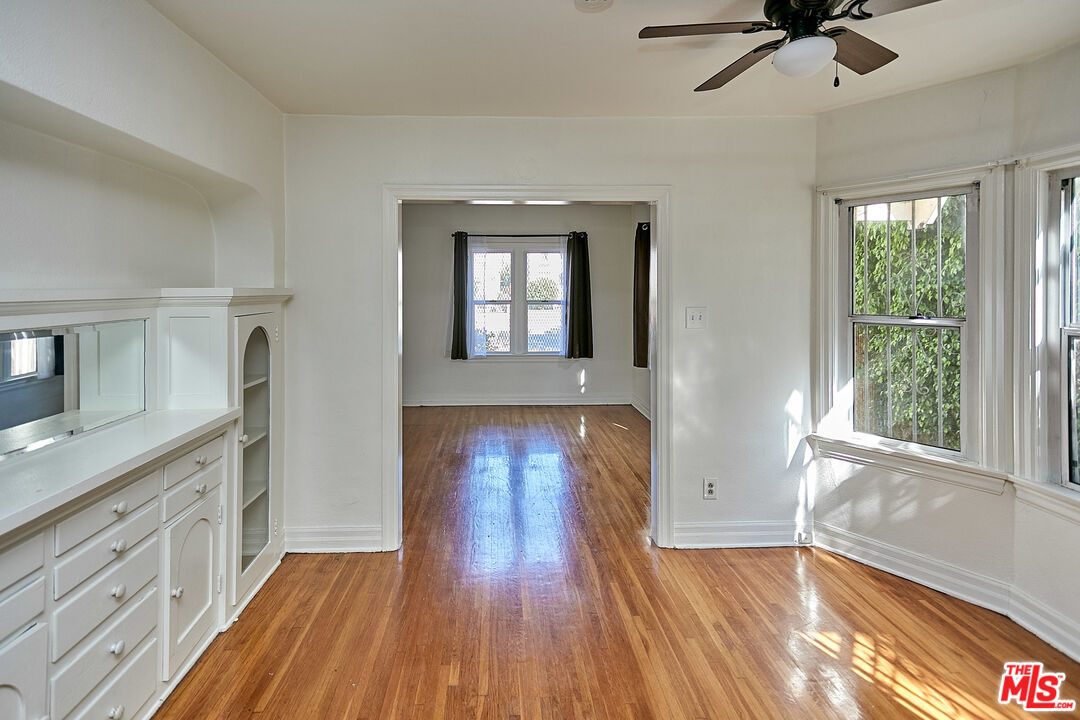1253 Keniston Avenue Los Angeles, CA 90019 - Photo 14 of 35 a view of livingroom with hardwood floor and a window