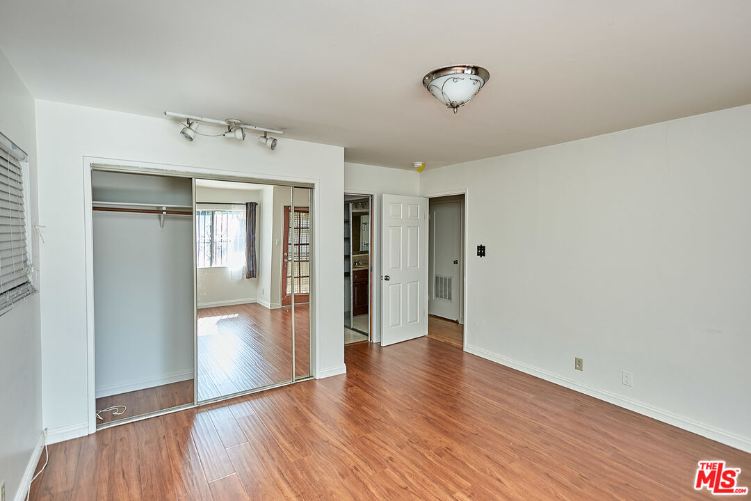 1253 Keniston Avenue Los Angeles, CA 90019 - Photo 23 of 35 a view of an empty room with wooden floor and a closet
