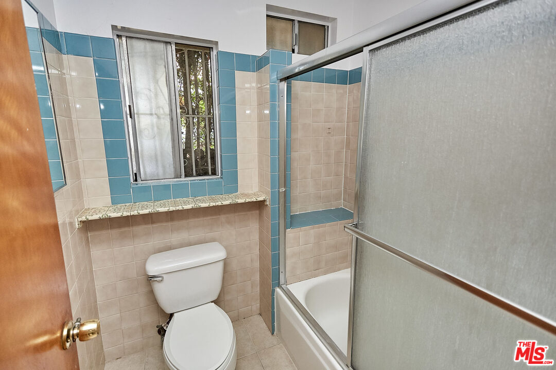 1253 Keniston Avenue Los Angeles, CA 90019 - Photo 26 of 35 a bathroom with a toilet and a shower