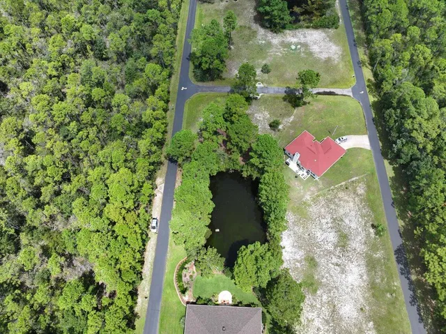 an aerial view of residential house with yard and outdoor space