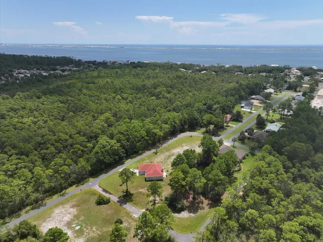 a view of a lush green outdoor space with a swimming pool and valleys