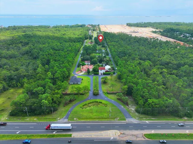 a sign board with tall buildings in the background