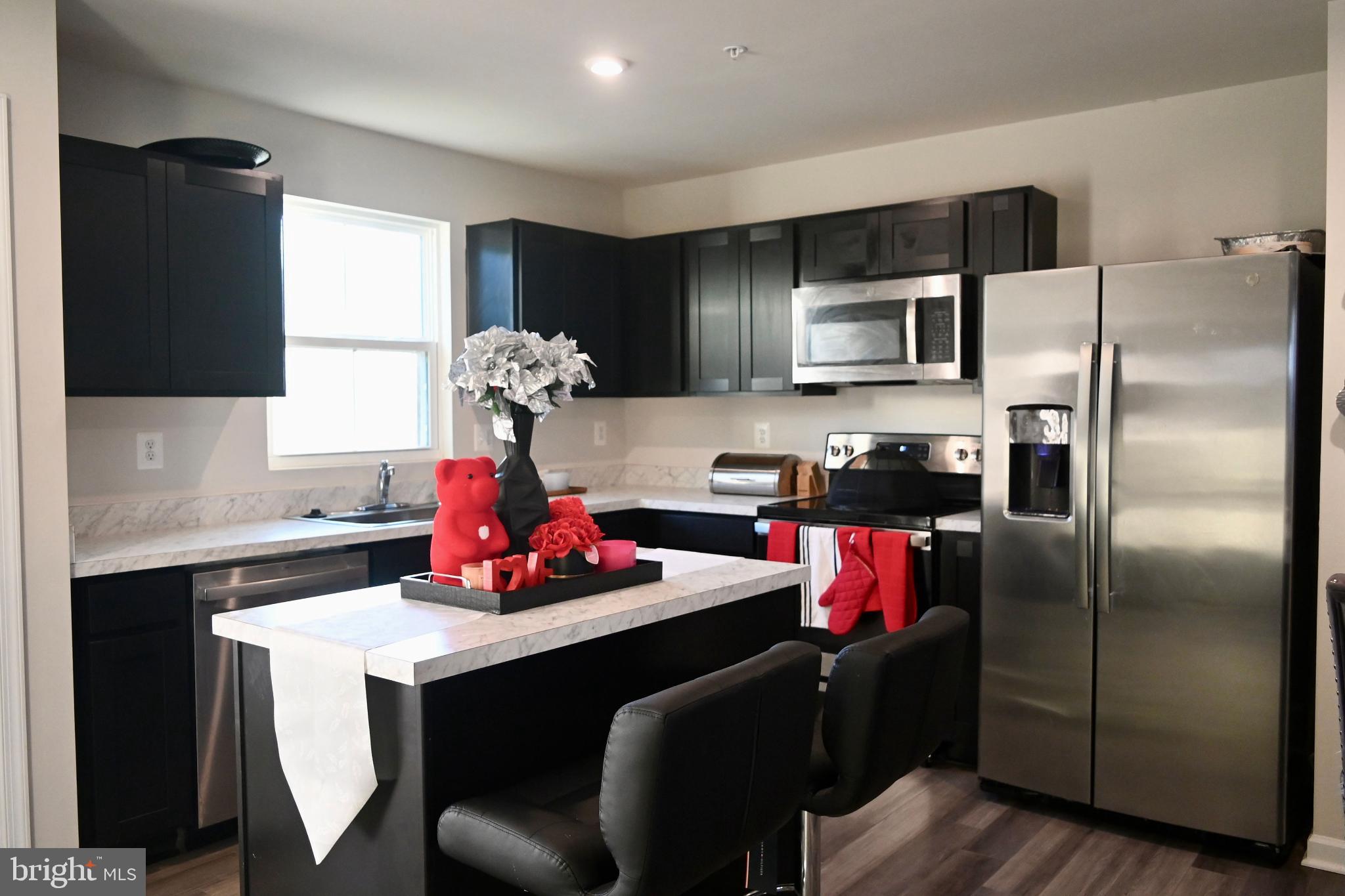 110 Mariners Way Cambridge, MD 21613 - Photo 11 of 41 Modern kitchen with sleek black cabinetry.