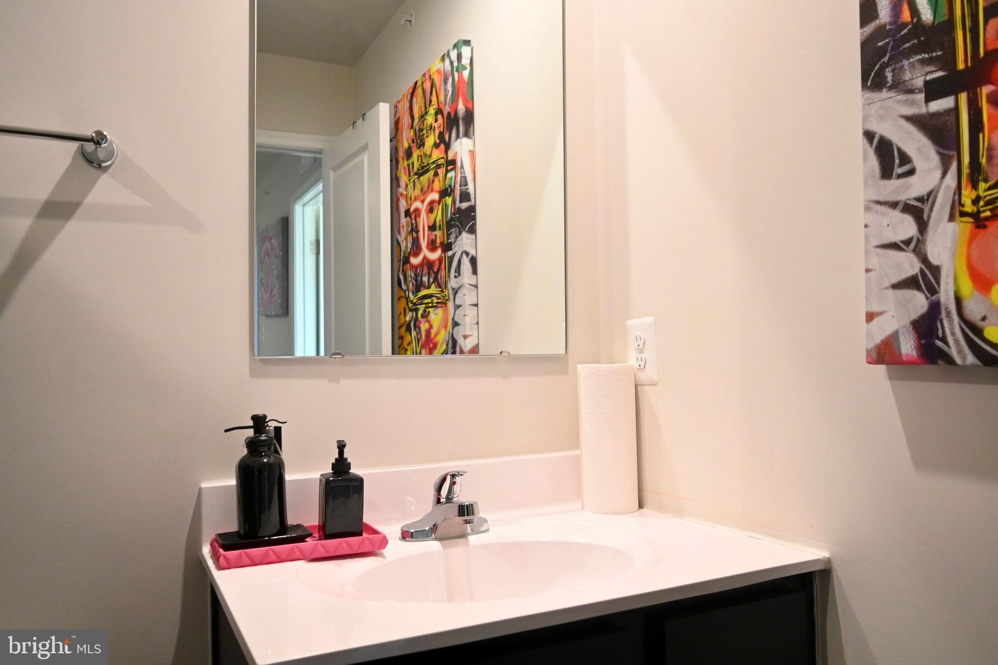 110 Mariners Way Cambridge, MD 21613 - Photo 29 of 41 Modern bathroom with vibrant artwork accents.