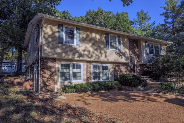 a front view of a house with a garden