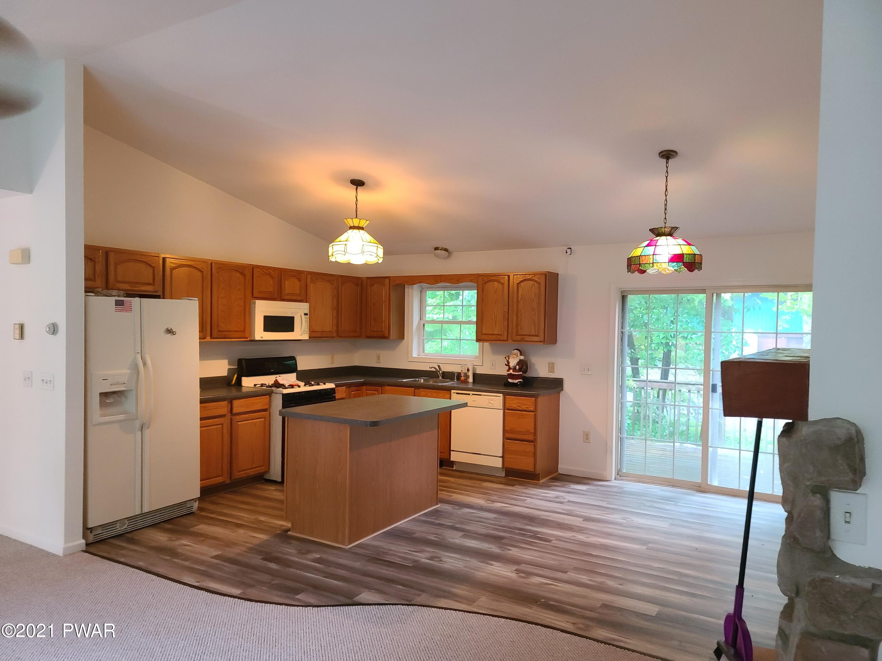 100 Kiel Road Milford, PA 18337 - Photo 10 of 45 a kitchen with stainless steel appliances granite countertop a sink dishwasher a refrigerator and a stove with wooden floor