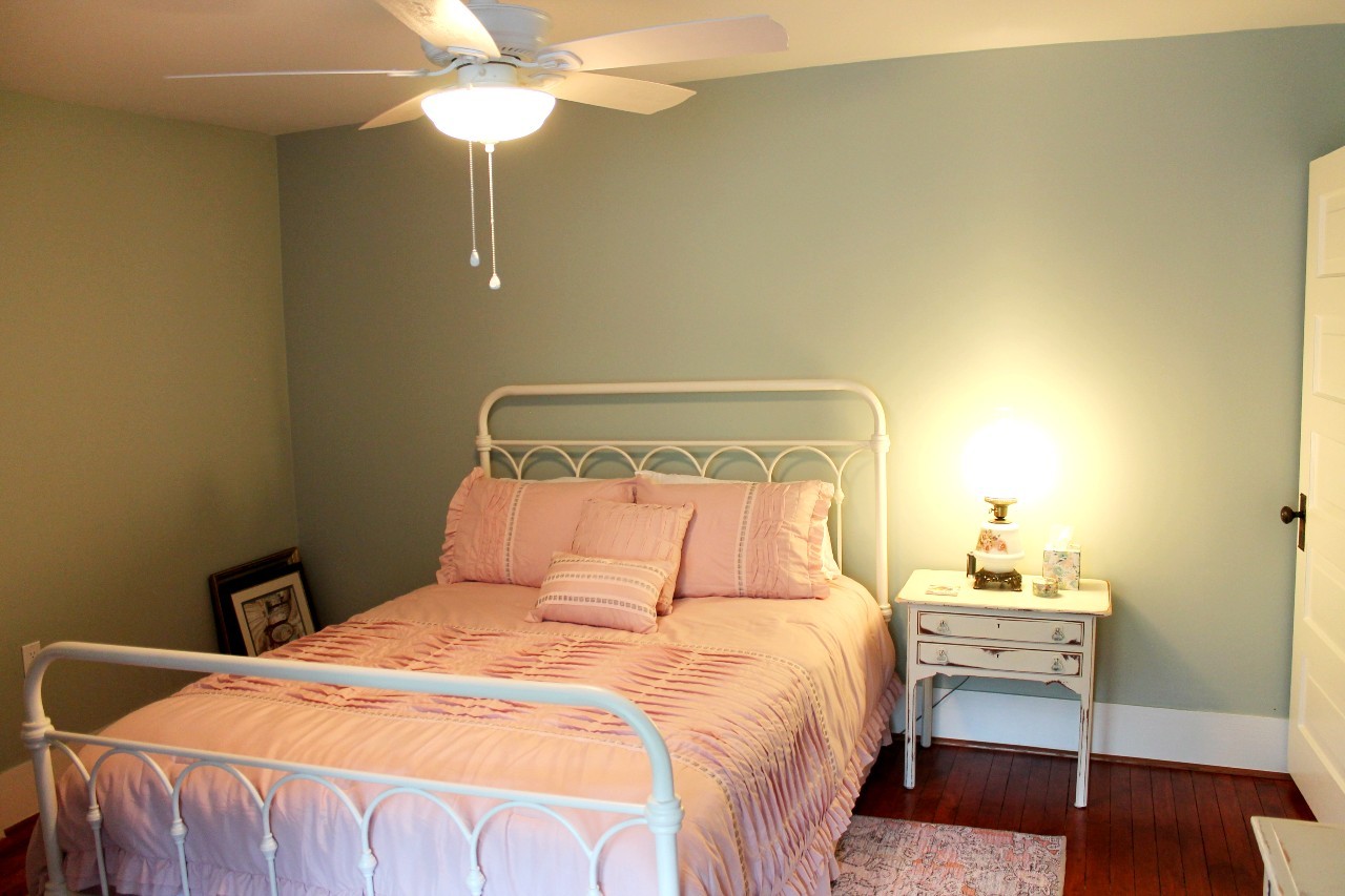 292 High Street Morrison, TN 37357 - Photo 26 of 39 a bedroom with a bed and a chandelier