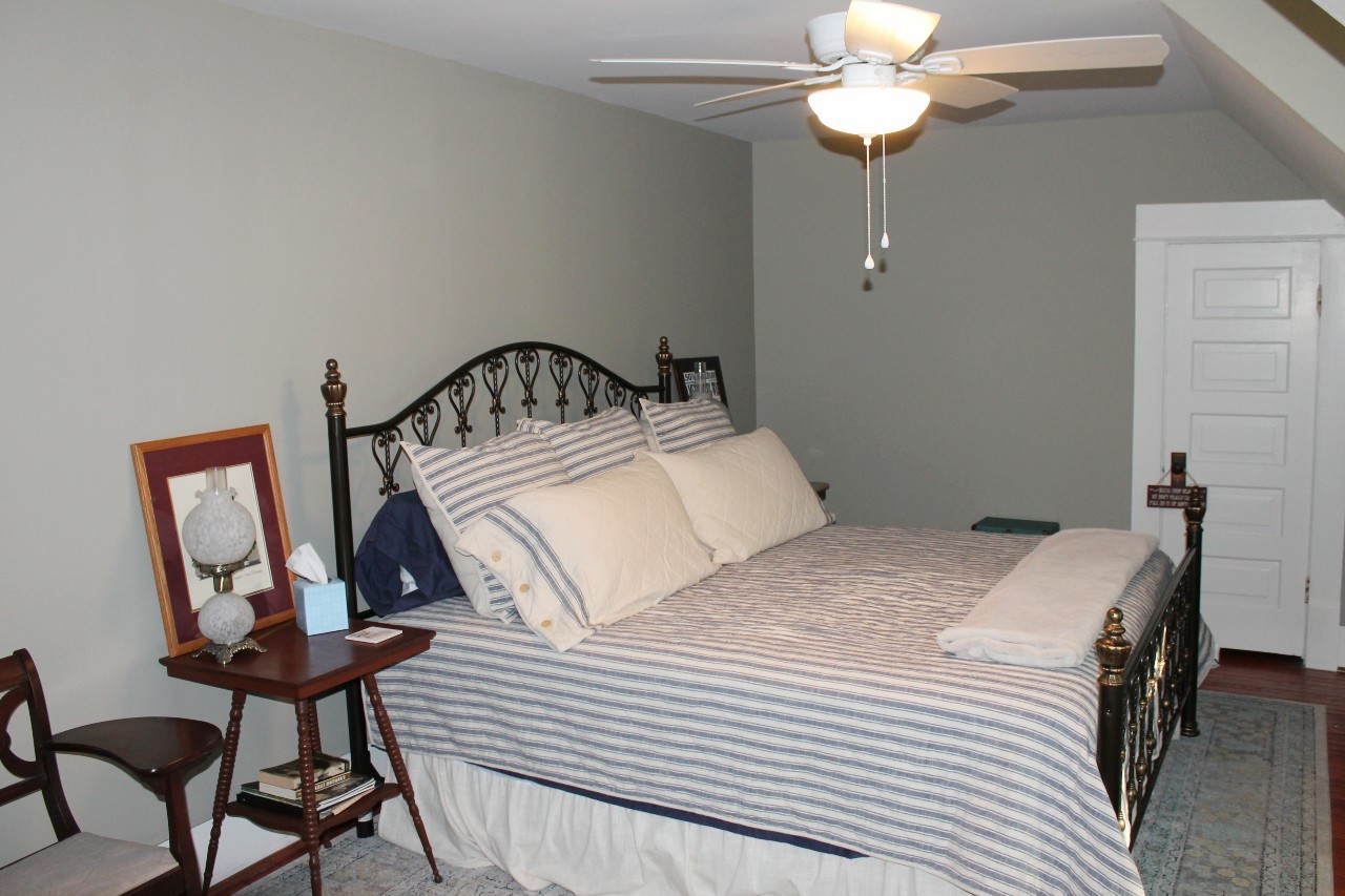 292 High Street Morrison, TN 37357 - Photo 30 of 39 a bedroom with a bed a chandelier and a dresser
