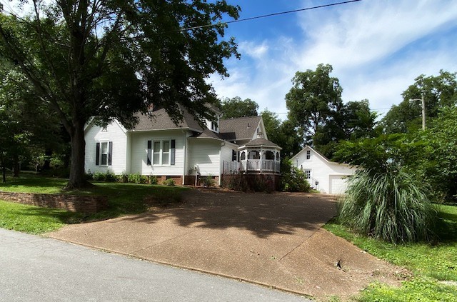 292 High Street Morrison, TN 37357 - Photo 36 of 39 a front view of a house with a yard and garage