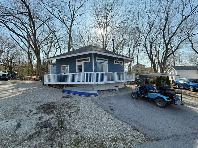 a view of a house with a yard and sitting area
