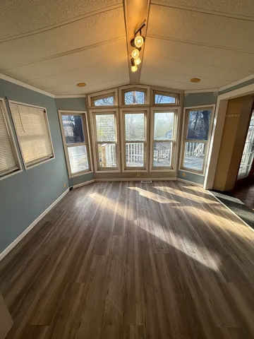a kitchen with granite countertop a sink cabinets and stainless steel appliances