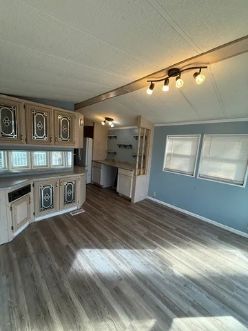 a kitchen with cabinets a refrigerator and a stove