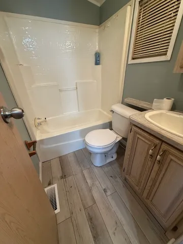 a view of a room with wooden floor and window