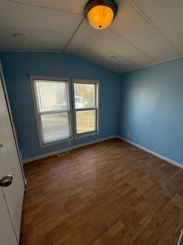 a view of a living room with wooden floor