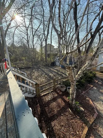 a view of balcony with wooden floor and fence