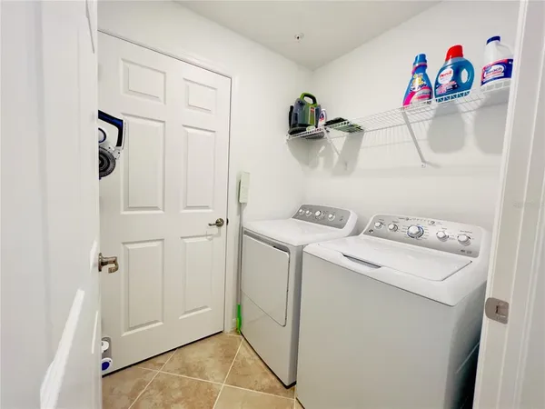 a living room with furniture and floor to ceiling windows