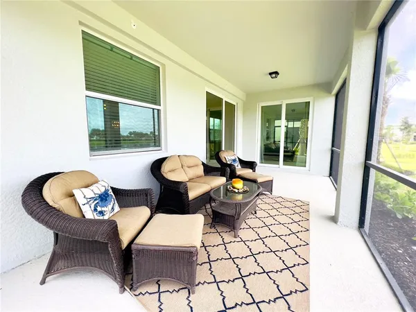 a living room with furniture and a floor to ceiling window