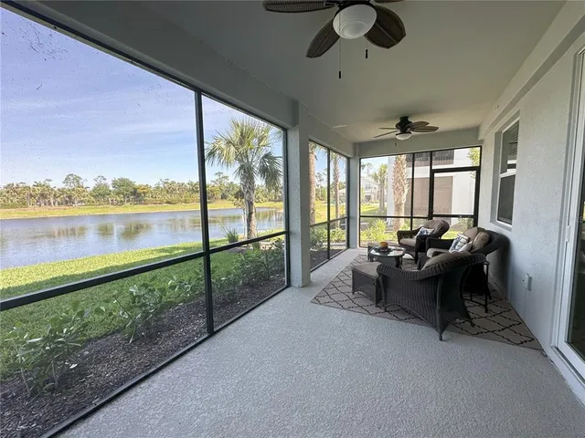 a living room with furniture and a floor to ceiling window