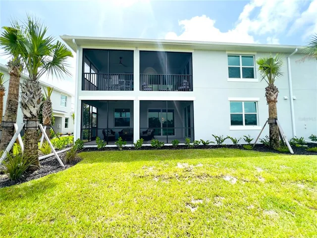 a front view of a house with garden and trees