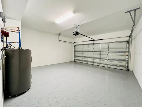 a view of a house with a yard and palm trees