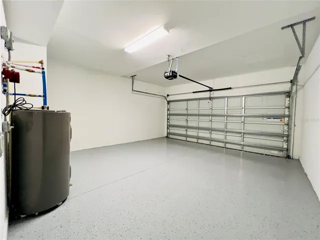 a view of a house with a yard and palm trees