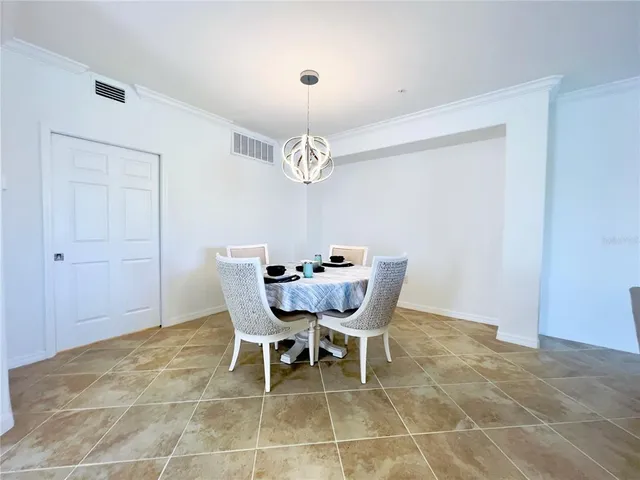 a dining room with furniture and chandelier
