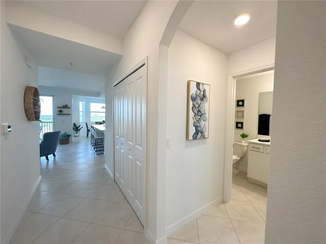 a view of a hallway with bathroom and a bathroom