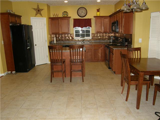 2038 Fiona Way Spring Hill, TN 37174 - Photo 3 of 20 Kitchen has newly tiled floors, plenty of cabinets and counter space, AND a HUGE walk in pantry. The kitchen flows right into the Great Room.