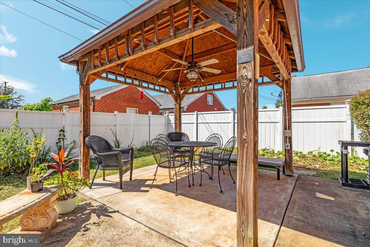 605 Happy Creek Road Front Royal, VA 22630 - Photo 17 of 19 a view of a patio with table and chairs potted plants with wooden floor