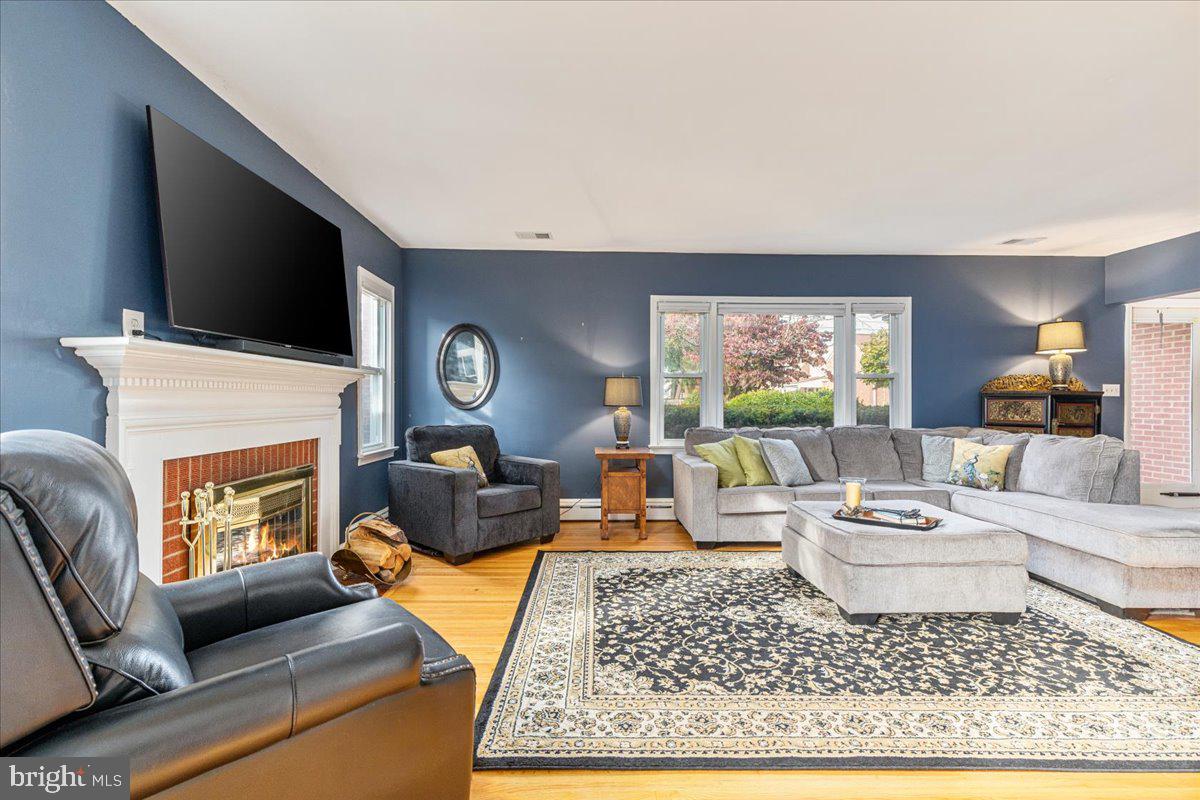 605 Happy Creek Road Front Royal, VA 22630 - Photo 5 of 19 a living room with furniture a flat screen tv and a fireplace