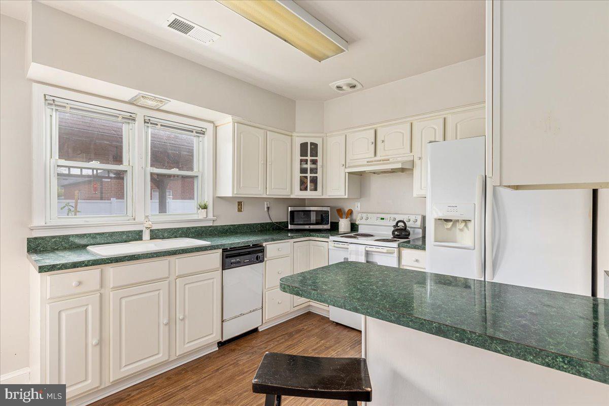 605 Happy Creek Road Front Royal, VA 22630 - Photo 9 of 19 a kitchen with stainless steel appliances granite countertop a stove a sink and a refrigerator