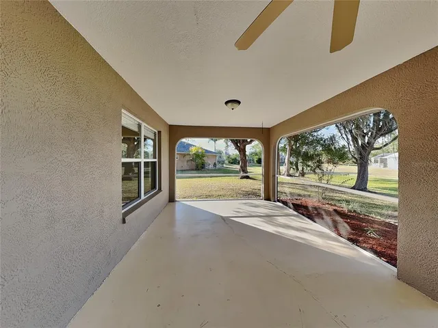 a view of a yard in front of a house with large tree
