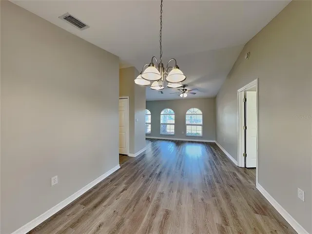 a view of a room with wooden floor