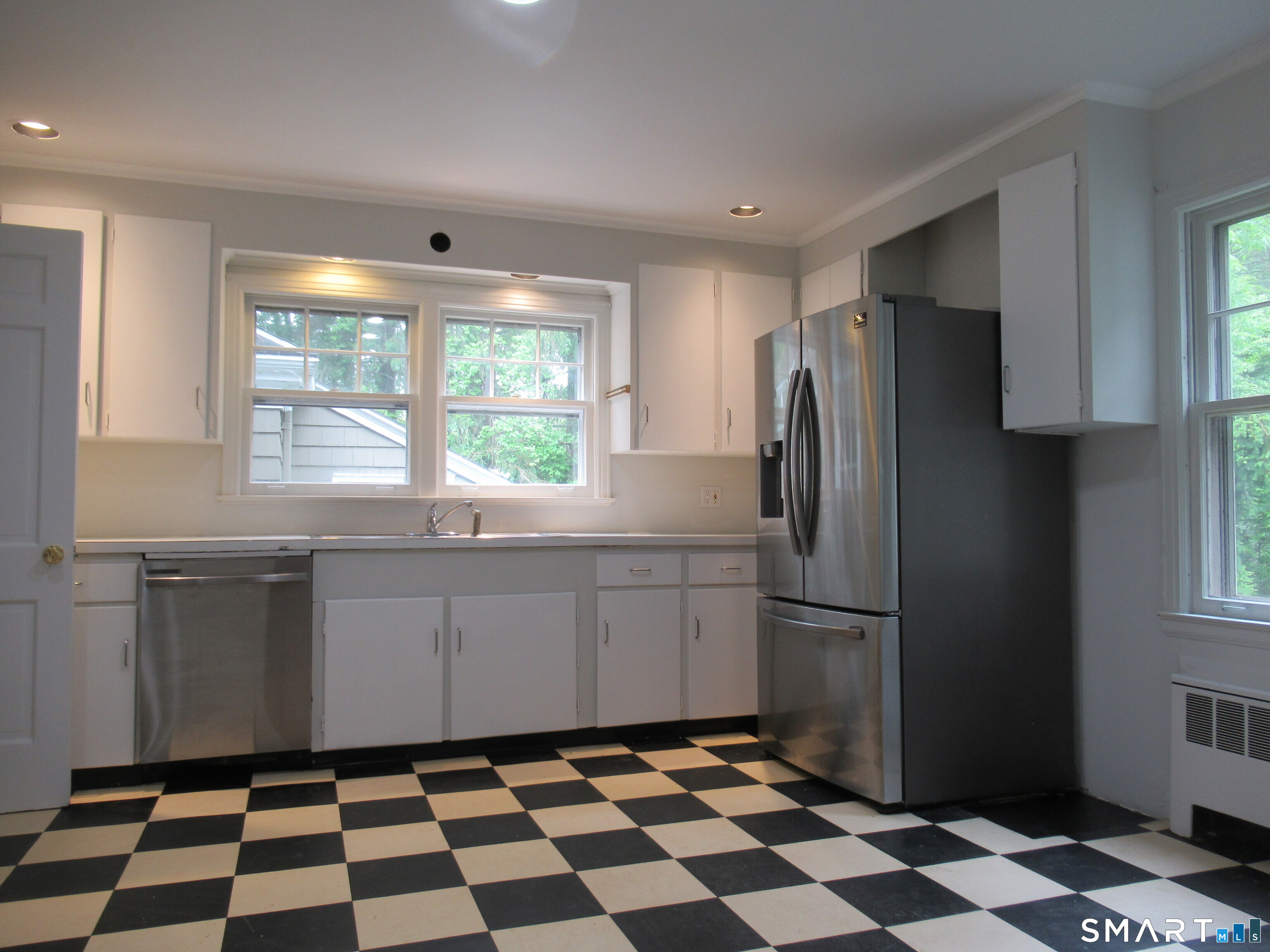 11 Burnt Swamp Road Woodbridge, CT 06525 - Photo 9 of 29 a kitchen with a refrigerator a sink and mirror