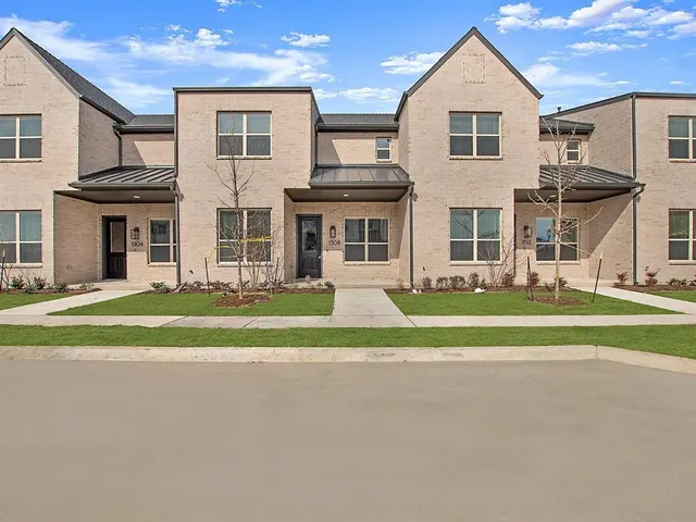 a view of a house with a big yard and large trees