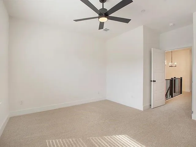a view of a room with a ceiling fan
