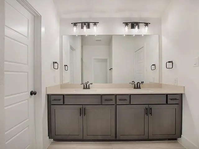a bathroom with a sink and mirror