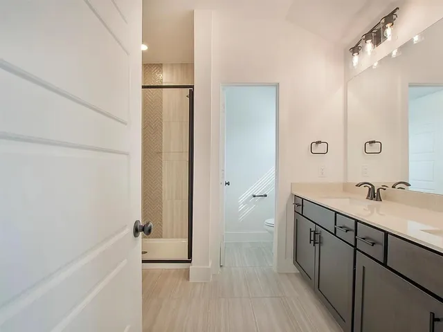 a bathroom with a tub sink vanity and a mirror