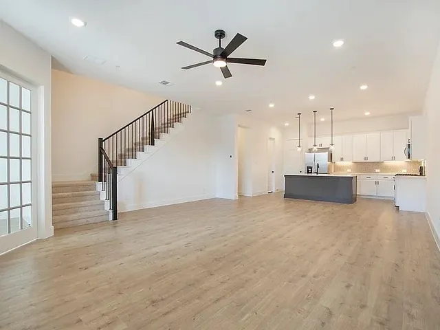 a view of a kitchen with a sink and wooden floor