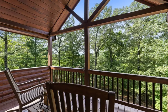 a bedroom with two beds and a ceiling fan