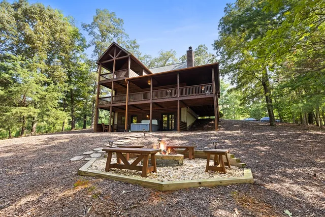 a view of a patio with table and chairs and potted plants with large tree